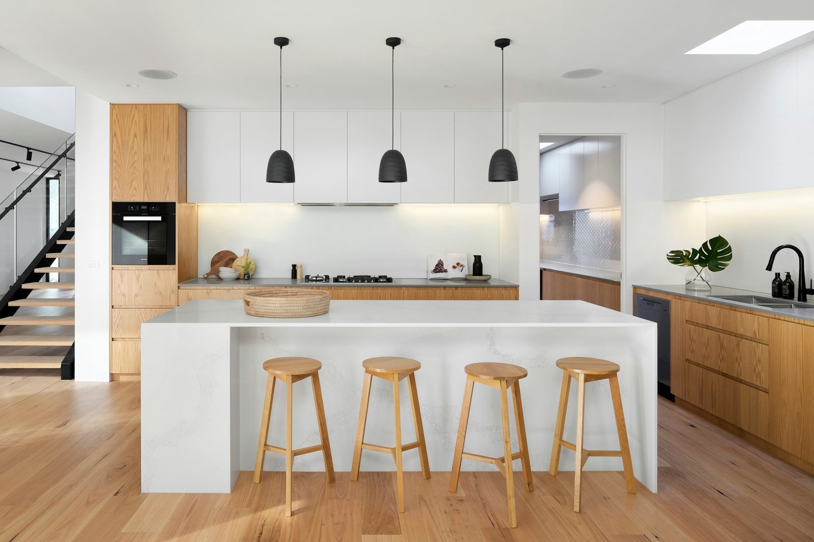 Modern luxury custom kitchen cabinets with quartz waterfall island installed in Kitchener, Ontario